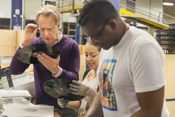 <p>Ton Vermeulen and a couple of co-workers inspect the quality of a newly pressed record. © Iggesund<br /><br /></p>