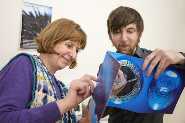 <p>Sallyanne Theodosiou, Senior Lecturer Graphic Design at the University of the Creative Arts in Epsom, and Mike Morris, editor of Packaging Solutions are examining a laser cut card made on Invercote from Iggesund Paperboard.© Iggesund</p>